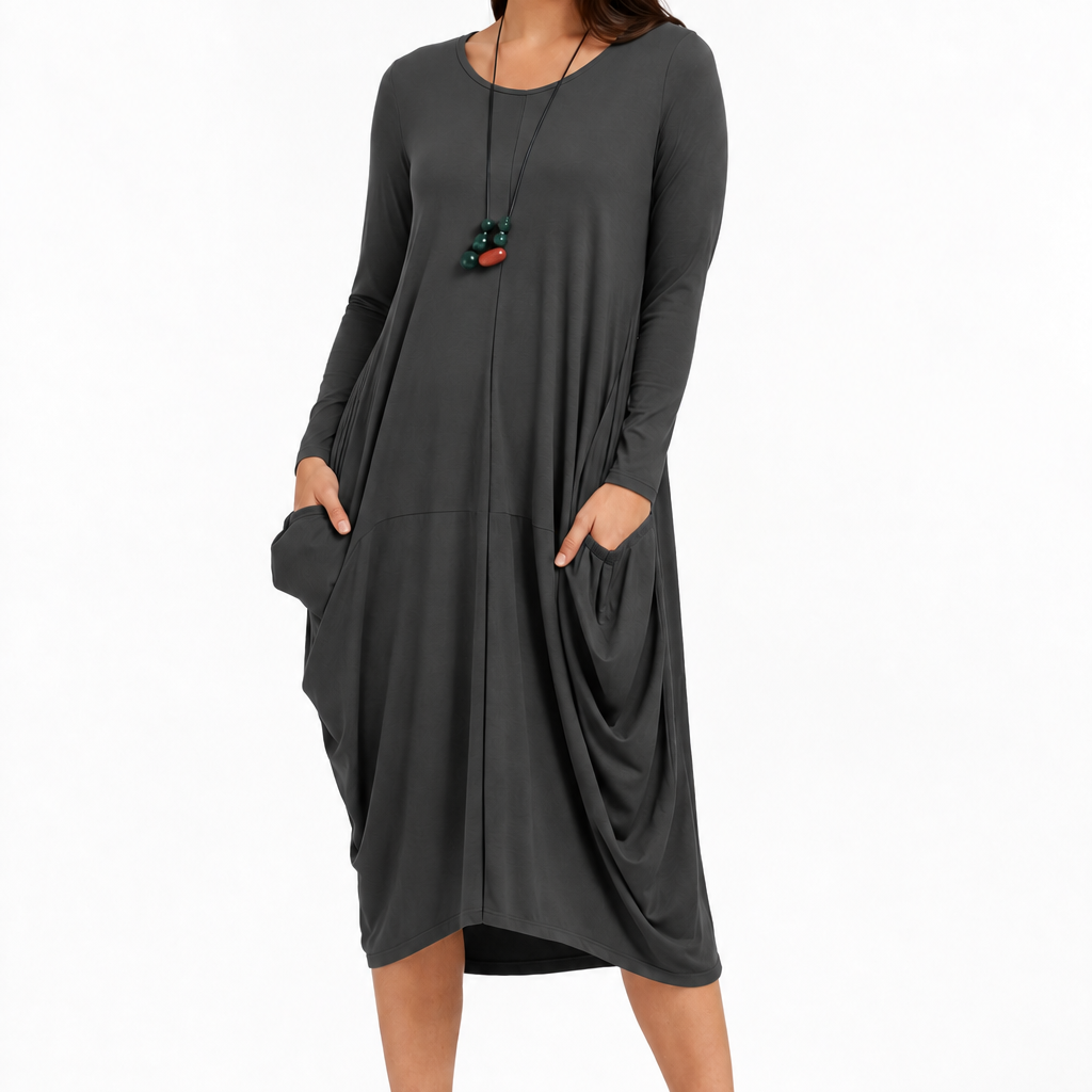 Leilani Dress in Graphite Grey – front view showing the round neckline, long sleeves and draped pockets