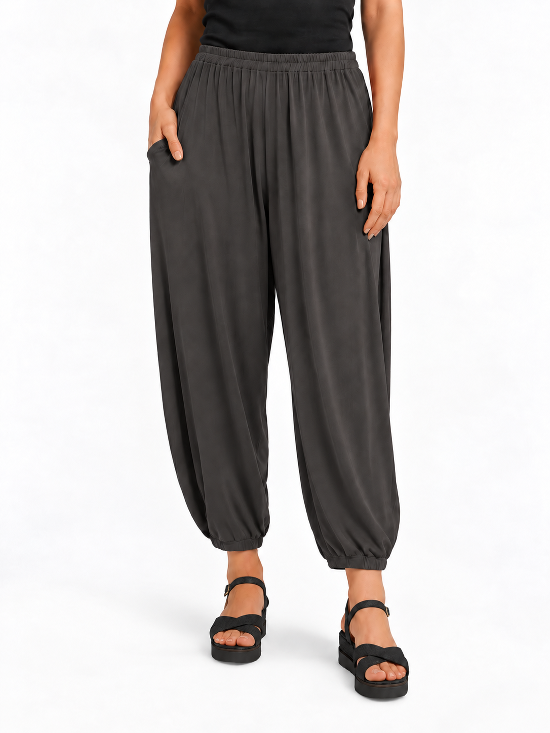 Front view of Graphite Grey Akira Barrel Pants, showing the elastic waistband, side pockets and tapered cropped legs.