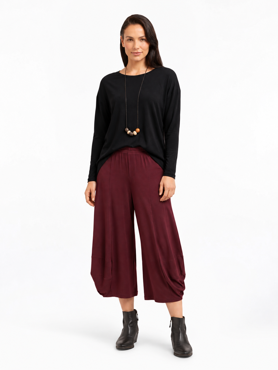 full body styled view of the Shiraz Red Marlee Wide Leg Pants styled with a relaxed top and ankle boots
