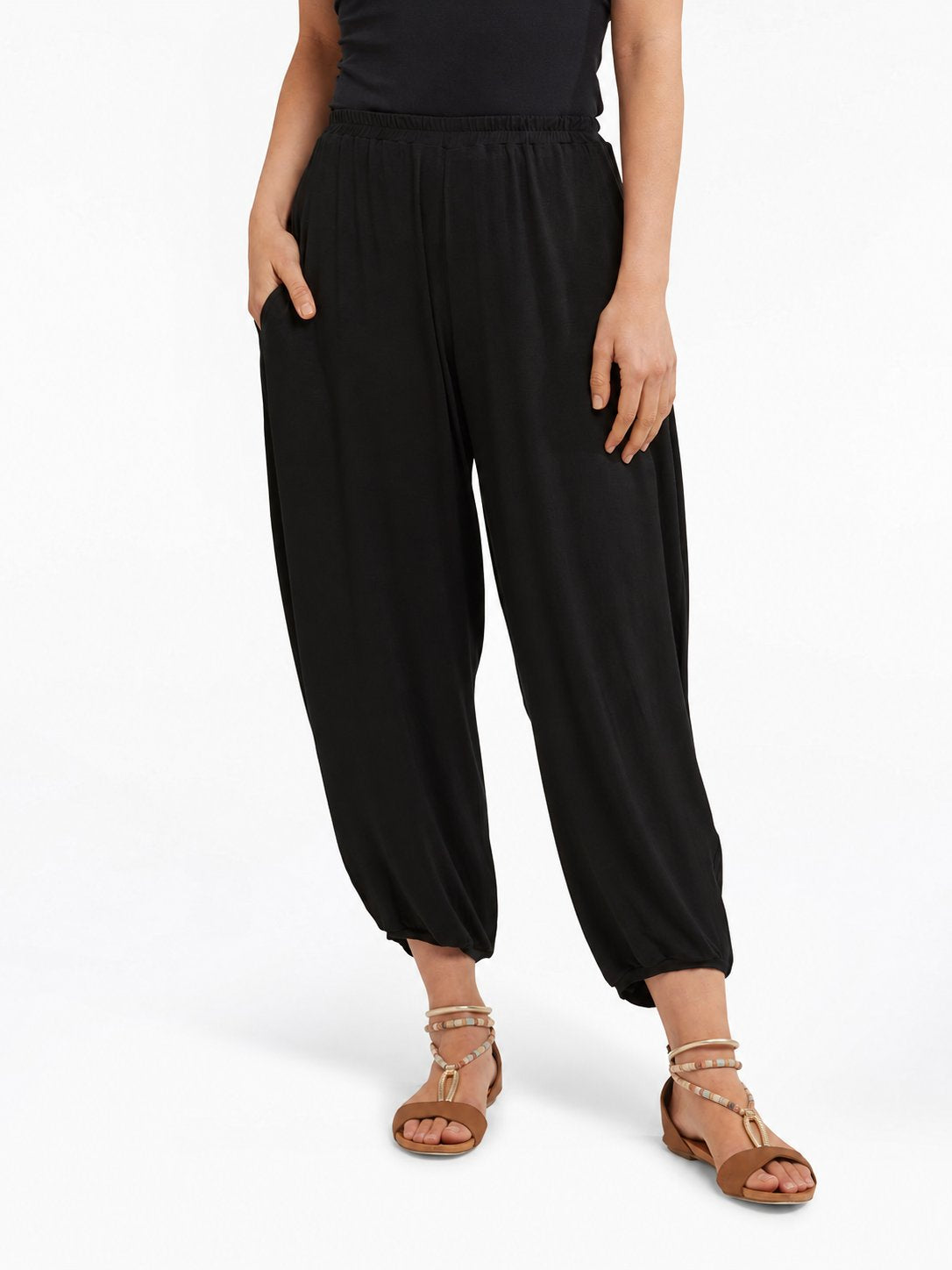 Front view of Black Akira Barrel Pants, showing the elastic waistband, side pockets and tapered cropped legs.