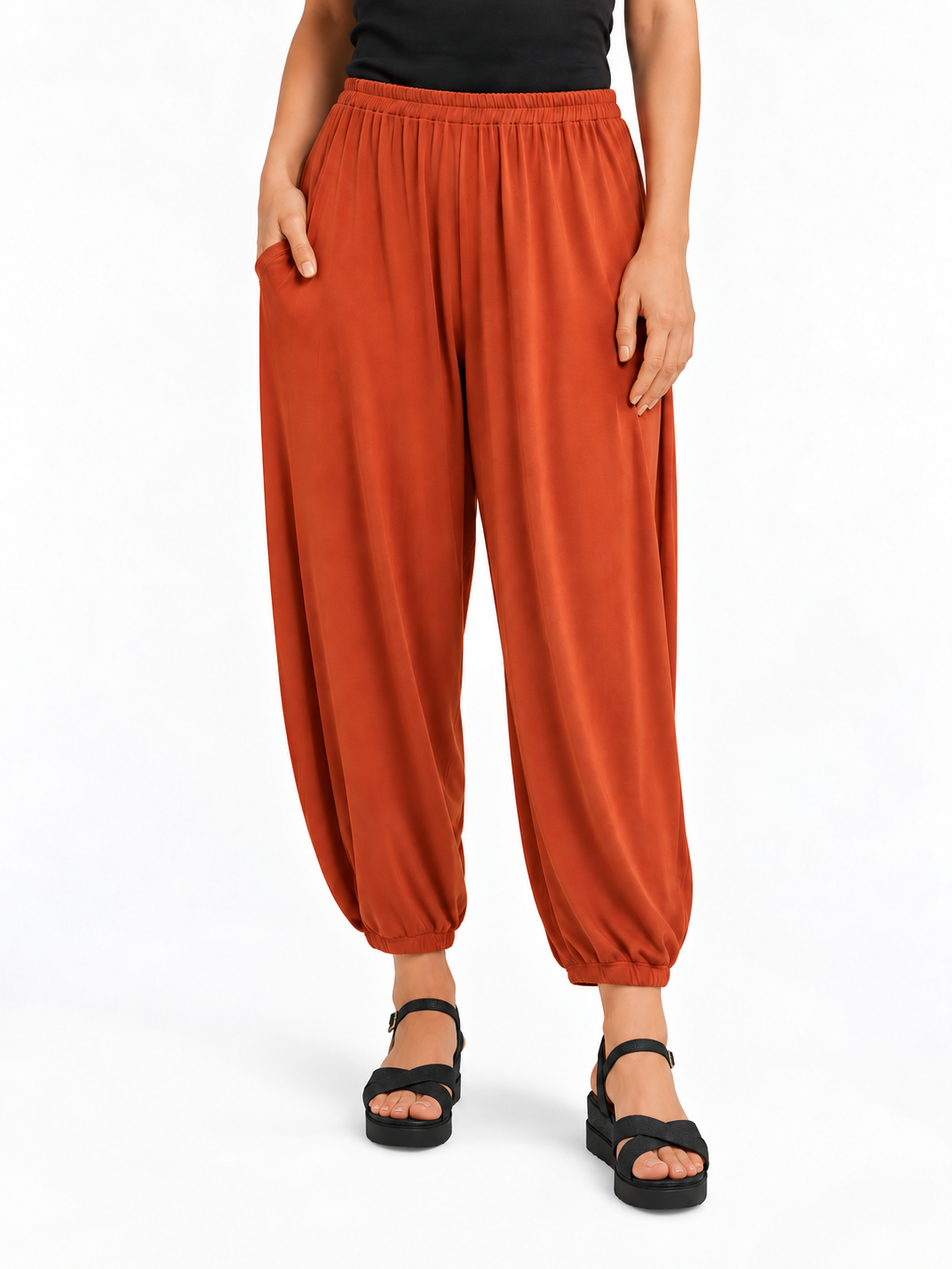 Front view of Rust Orange Akira Barrel Pants, showing the elastic waistband, side pockets and tapered cropped legs.