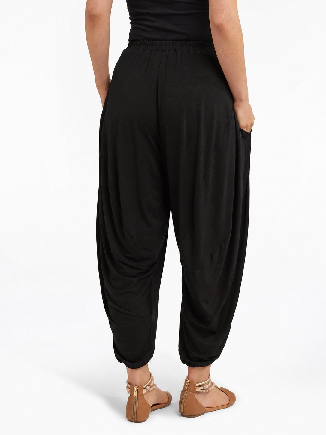 Back view of Black Akira Barrel Pants, showing the draping back panels and cropped cuffs.