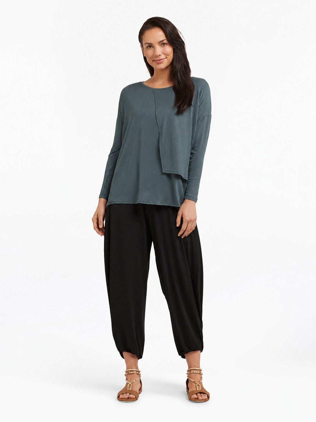 Full-body styled view of Black Akira Barrel Pants, worn with a relaxed top and sandals.